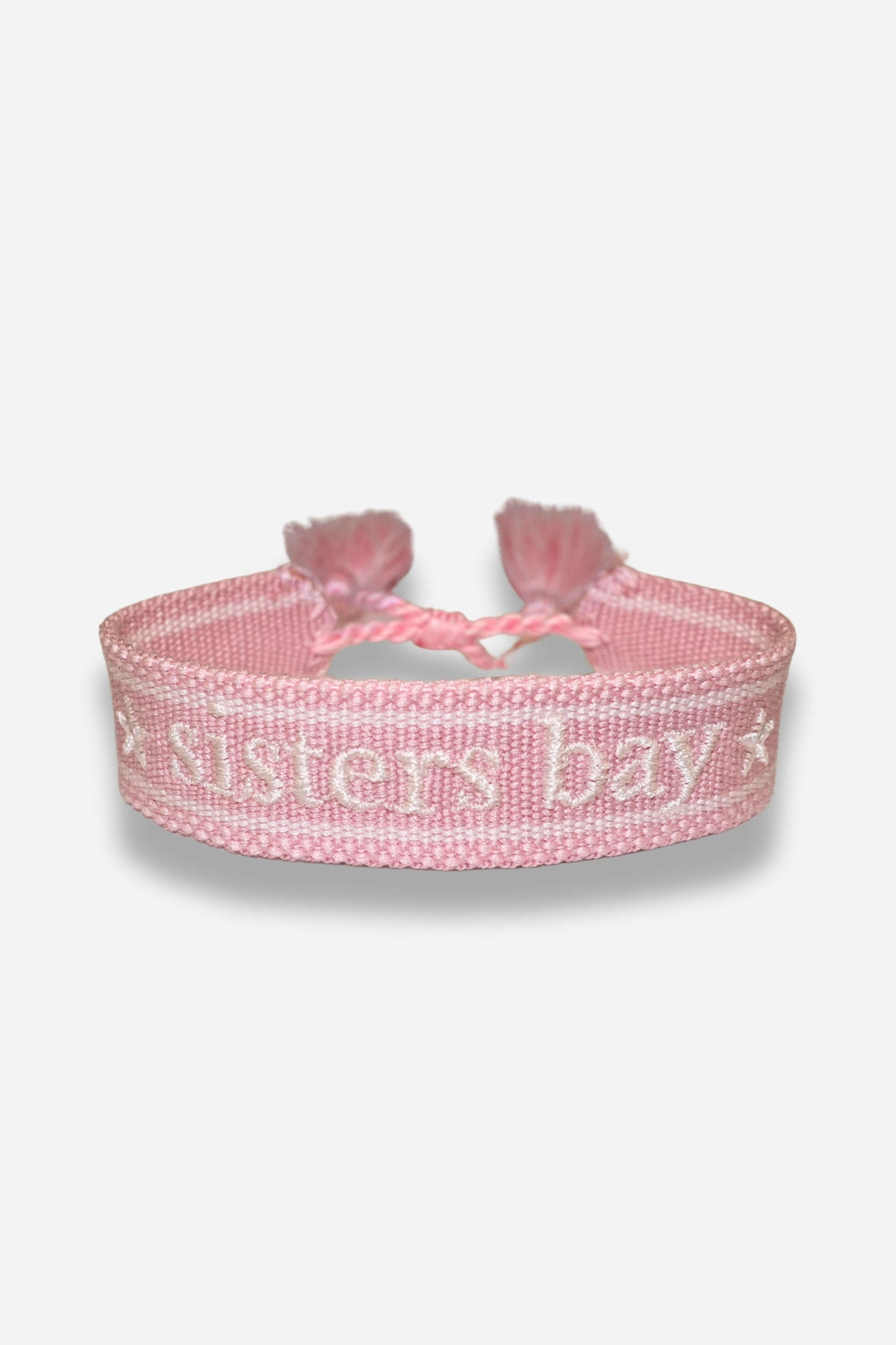 Bracelet tissé Sisters Bay, disponible en rose clair, navy et gris, avec nœud coulissant.