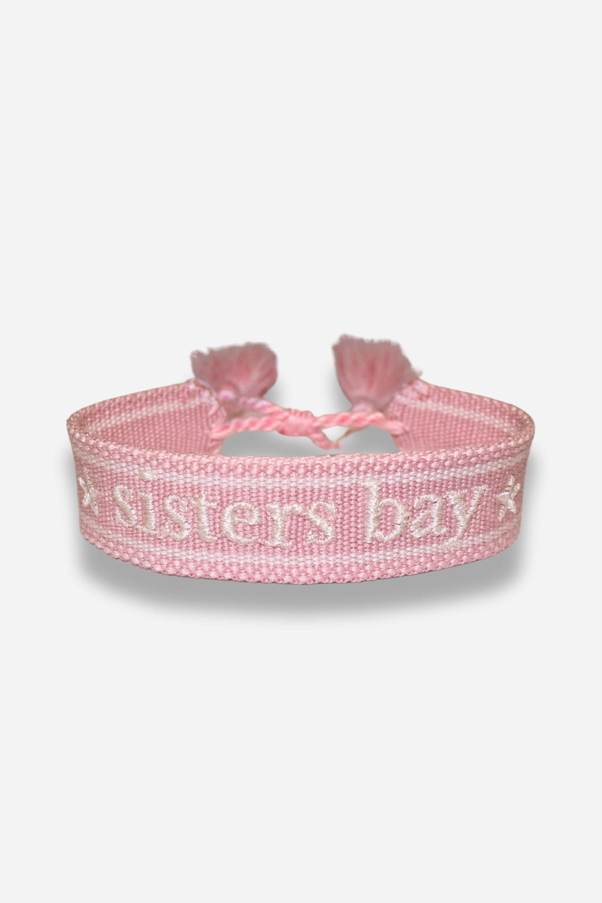Bracelet tissé Sisters Bay, disponible en rose clair, navy et gris, avec nœud coulissant.