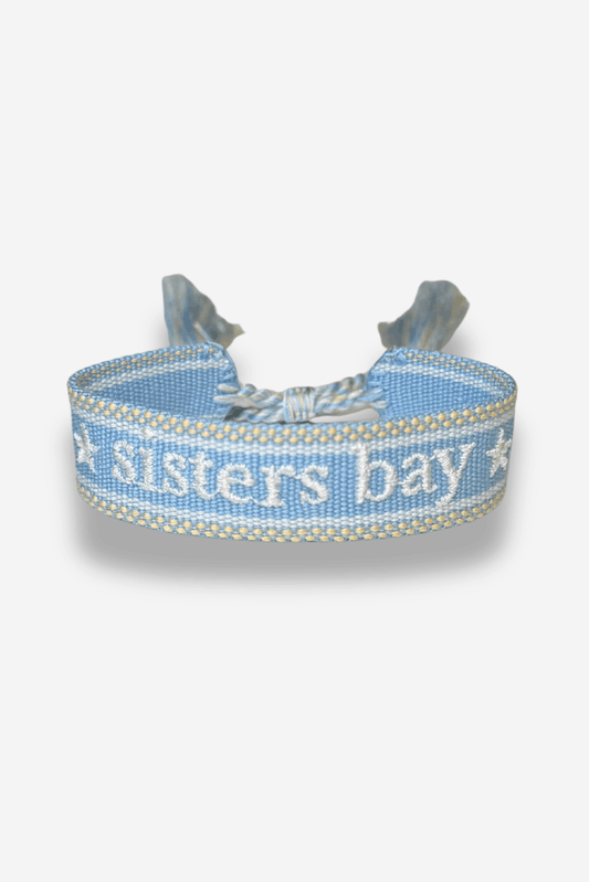 Bracelet tissé bleu clair, création exclusive Sisters Bay, brodé « ★ sisters bay ★ » avec longueur ajustable grâce à un nœud coulissant.
