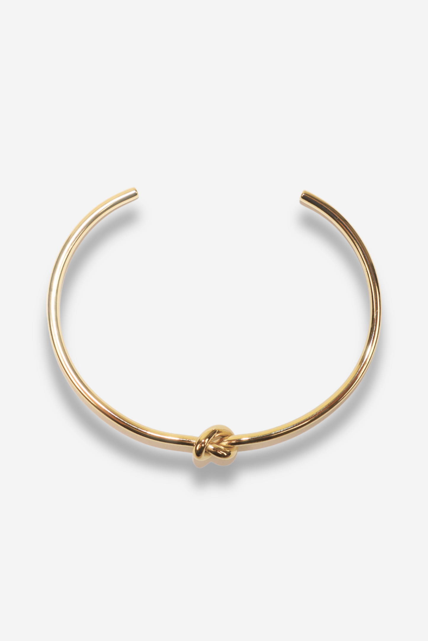 Bracelet jonc doré "HOPE" de chez SISTERS BAY, en acier inoxydable avec un effet nœud, taille ajustable et résistant à l'eau.